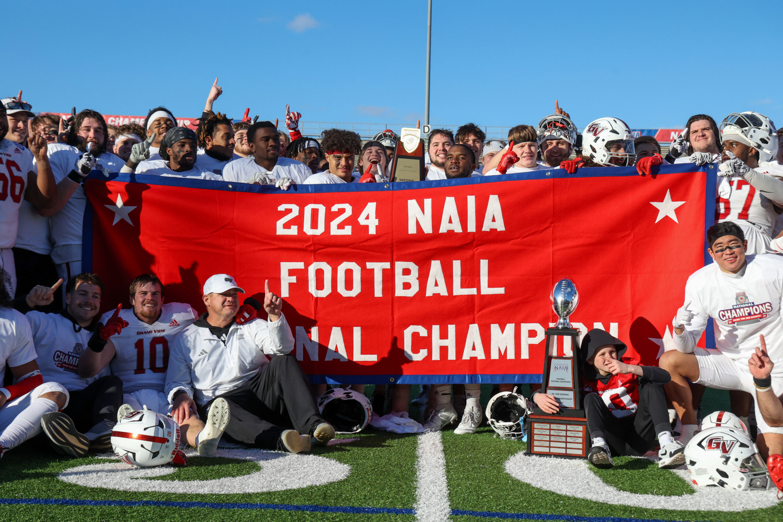 Football team holding championship banner