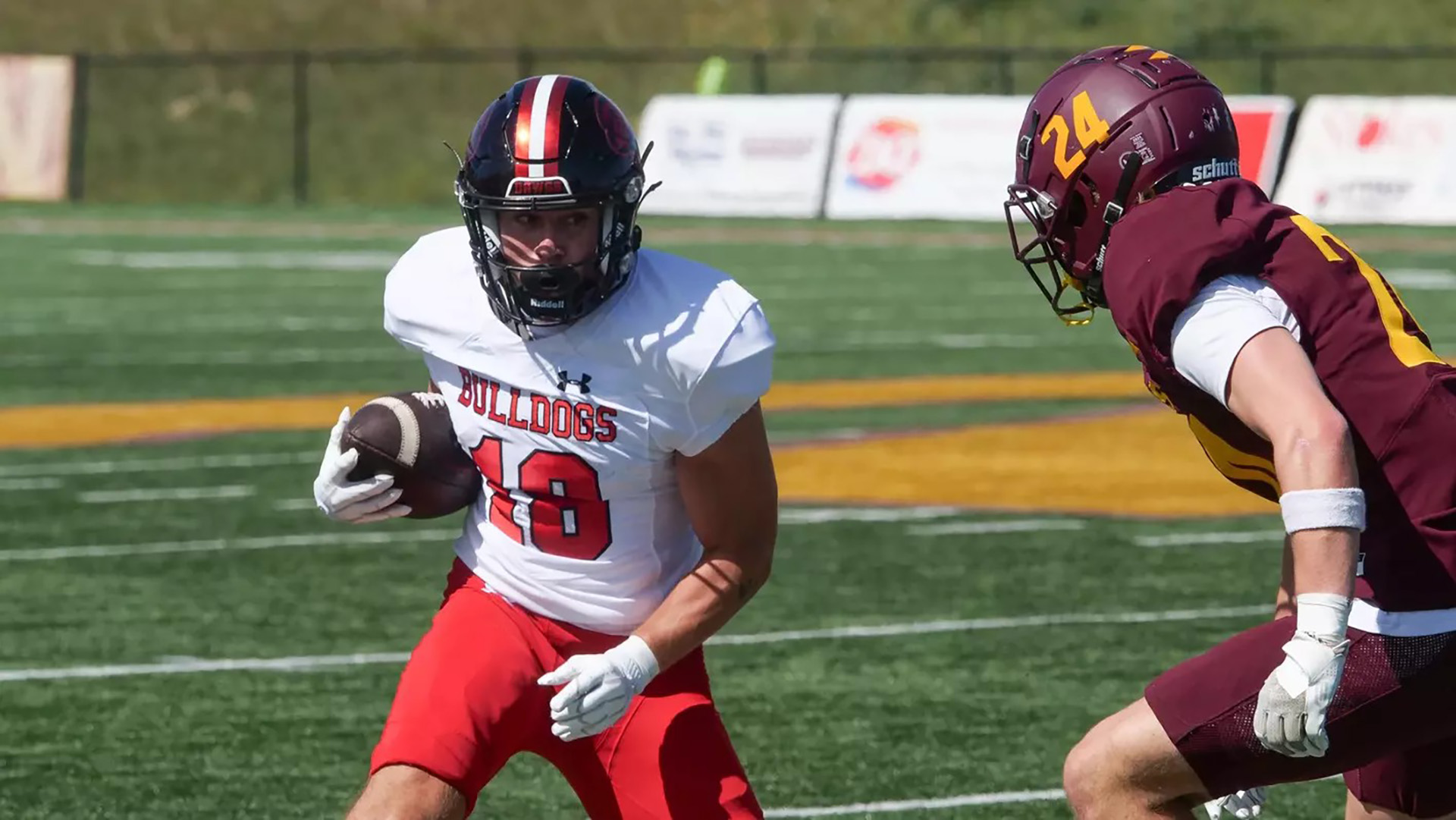 A Montana Western football player running with the ball.