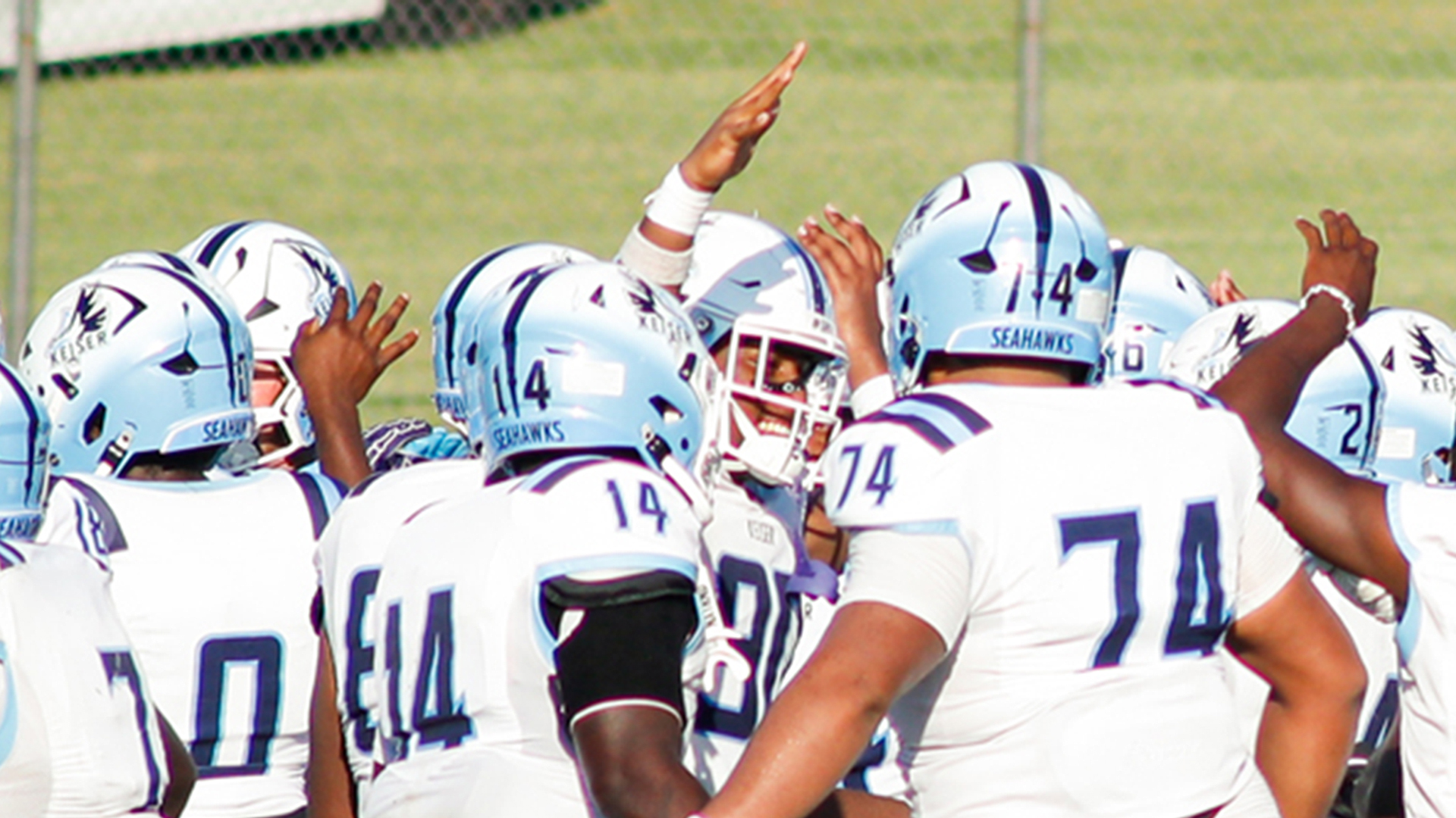 Football players from Keiser in Florida huddle during a game.