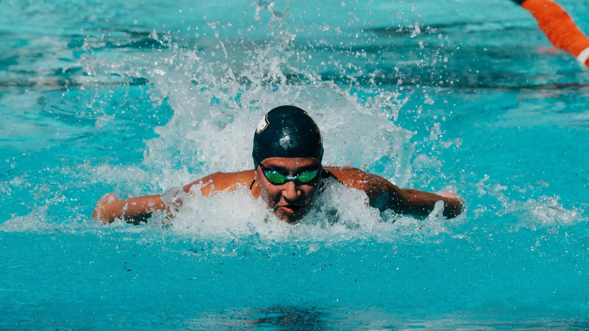 a swimmer swimming directly at the camera