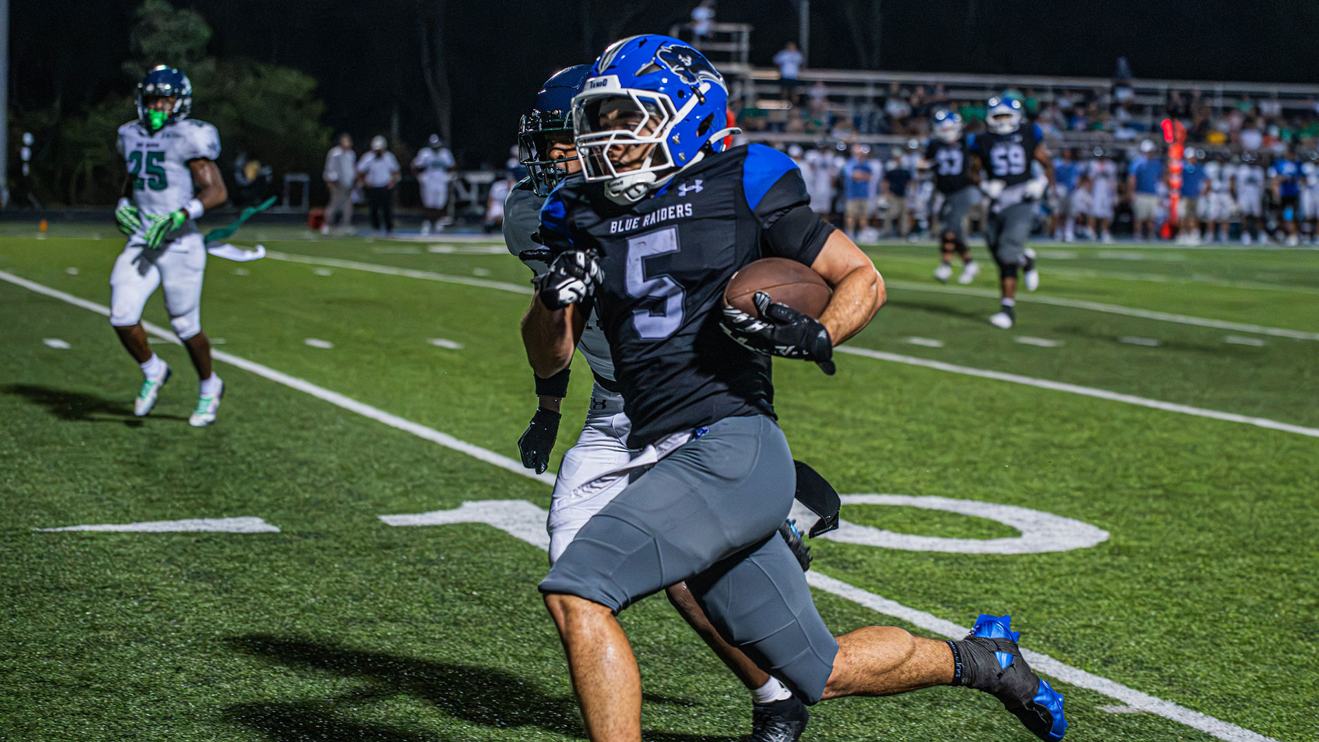 A football player running down the sidelines.