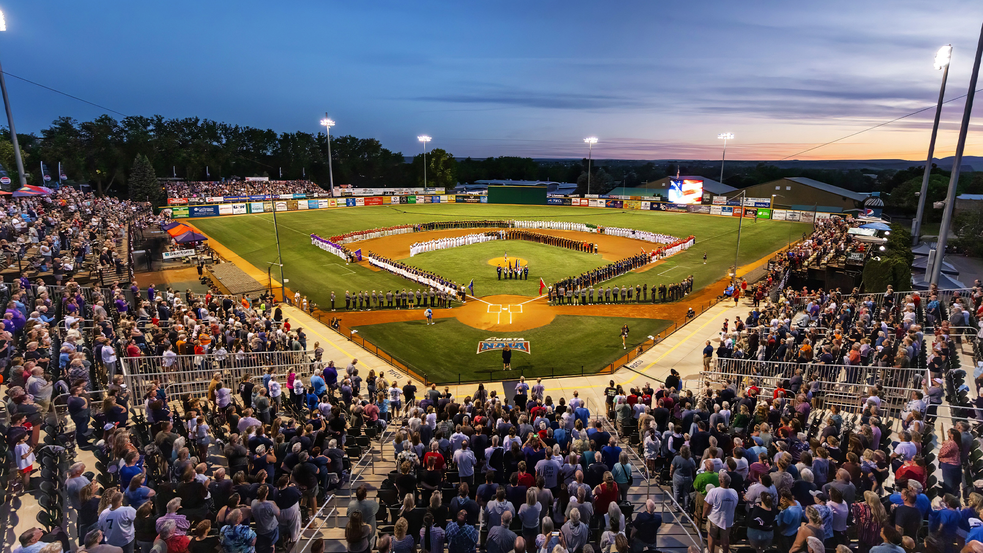 Photo of a baseball field at night under the lights