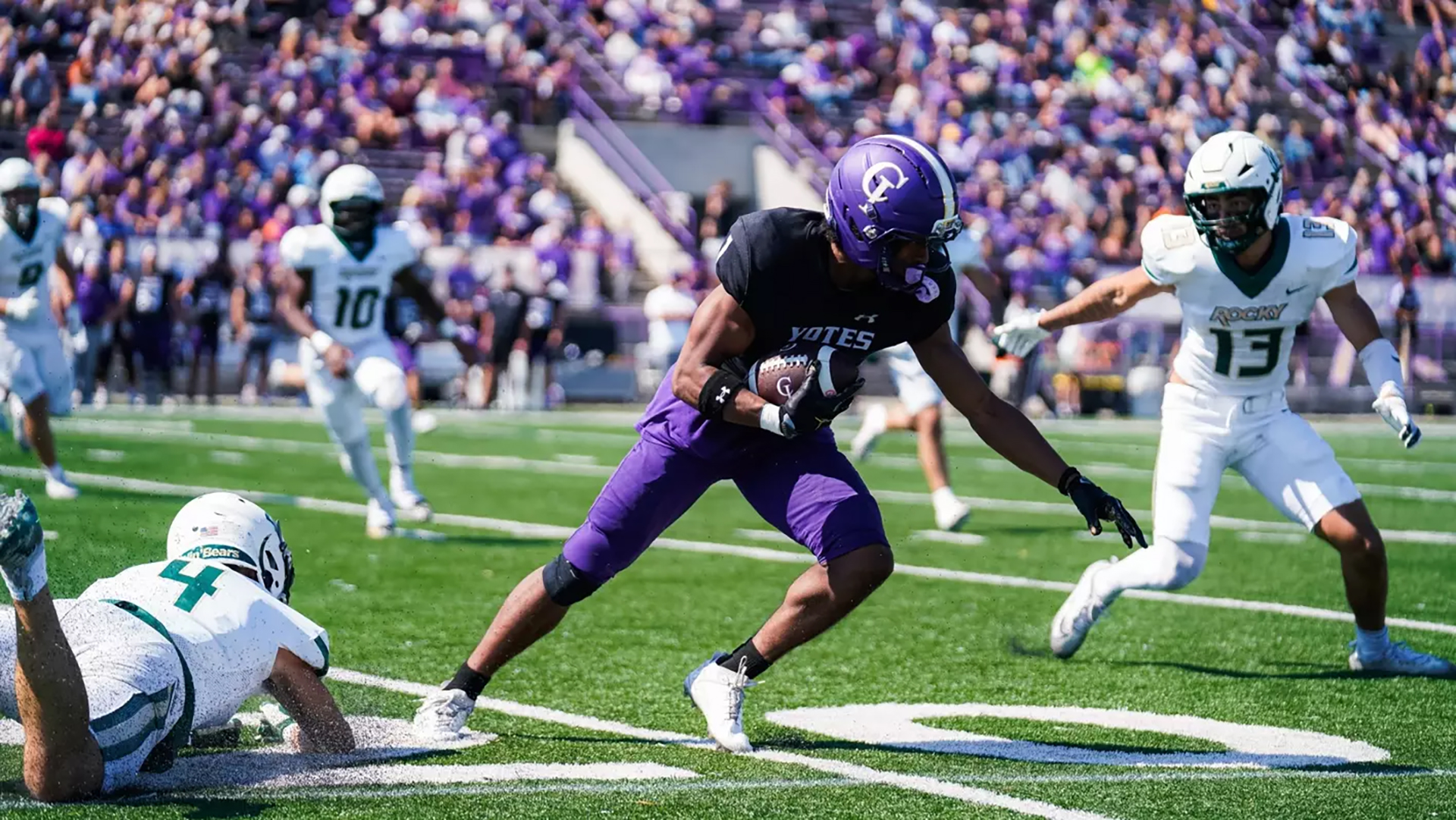 A player from College of Idaho carries the ball against Rocky Mountain College.