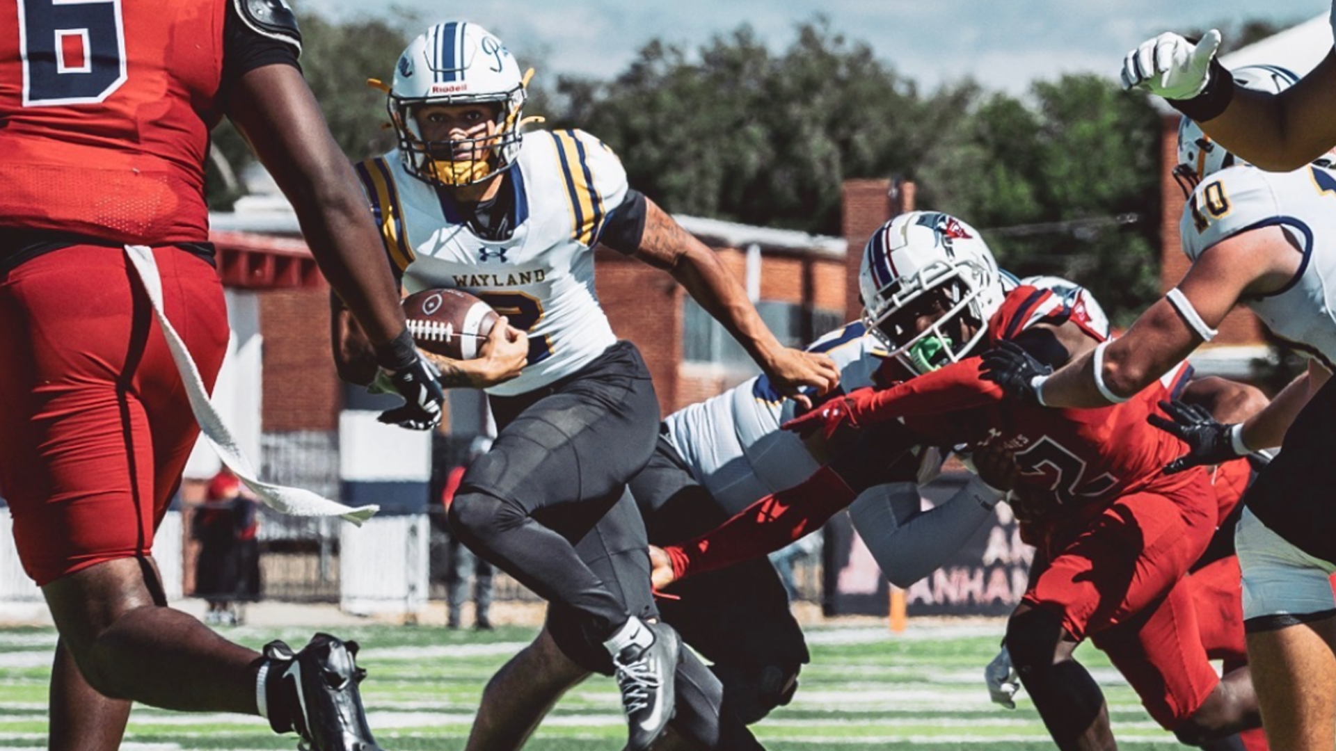 A football player running in a crowd.